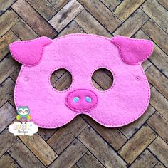 a pink pig mask sitting on top of a wooden floor