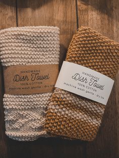 three handmade dish towels sitting on top of a wooden table next to each other