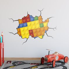 a wall decal with a lego car breaking through it's walls in a child's room