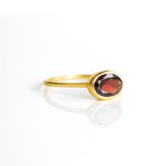 You'll fall in love with the deep red coloring of this Garnet ring. This is a perfectly sized oval to compliment any collection. Popular as a birthday gift for those January babes and Garnet lovers alike. This is a dark, transparent red gemstone with no flaws. This stone is beautifully faceted and bezel set in a 925 sterling silver band or plated with 18k vermeil gold. Gemstone is approximately 8 x 6mm.Band has 925 stamp on inside.Please note that each ring is handmade and there may be some slig Red Oval Cabochon Ring, Red Garnet Oval Cabochon Ring, Oval Red Gemstone Birthstone Ring, Red Oval Cabochon Ruby Ring For Gift, Oval Ruby Rings For Gift, Oval Ruby Rings Suitable For Gifts, Oval Garnet Ruby Ring As Gift, Oval Garnet Rings As Gift, Oval Ruby Filigree Ring As Gift