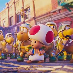 several cartoon characters are standing in front of a group of people on a city street