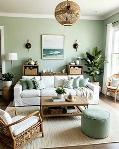 a living room with green walls and white furniture