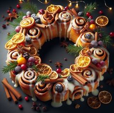 a christmas cake decorated with oranges, cinnamons and other holiday decorations on a black background