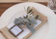 a place setting with napkins and flowers on it