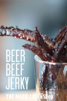 a close up of a glass with food in it and the words beer beef jerry