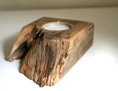 a wooden candle holder sitting on top of a table