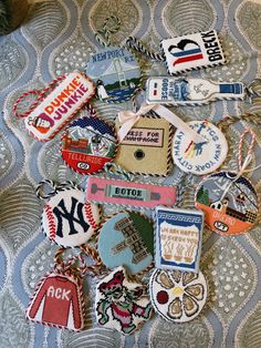 many different types of badges and tags on a bed