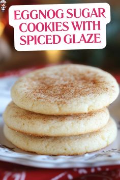 eggnog sugar cookies with spiced glaze are stacked on a white plate