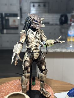 a predator action figure standing on top of a table