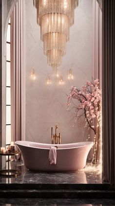 a bathroom with a tub and chandelier hanging from the ceiling in front of it