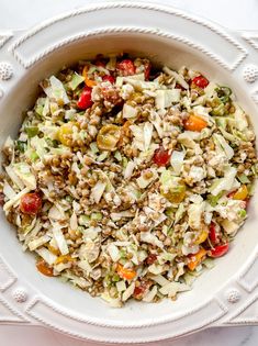 a white bowl filled with salad on top of a table