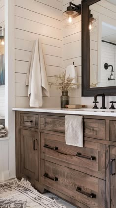 a bathroom with white walls and wooden cabinets