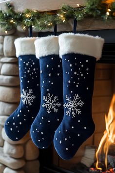 two christmas stockings hanging from a mantel