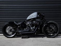 a black motorcycle parked in front of a garage door