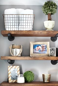 three wooden shelves with pictures and other items on them