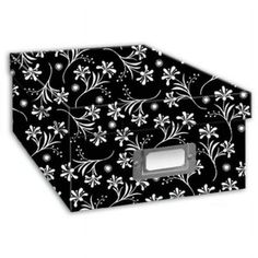 a black and white flowered tissue dispenser with silver foil on it