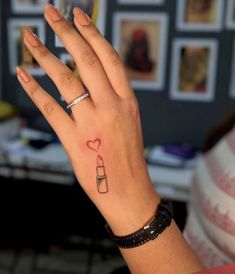 a woman's hand with a small tattoo on it