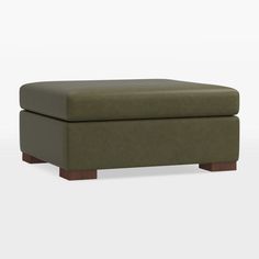 a green ottoman sitting on top of a white floor