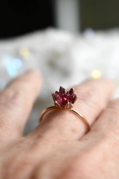 Spinel jewelry in 14K rose gold fill! Woweee I love this gemstone. A deep red Spinel gemstone lotus ring enveloped in pink gold. Spinel is known for its metaphysical energy renewal and vitality. It also closely relates to the Scorpio and Leo Zodiacs and also and August birthstone! Also called Ruby Spinel, it is the newest birthstone of August babies. Also available in sterling silver. This piece is ready to ship in a size 7. Or, hit the custom order button to have one made just for you, to size 14k Gold Filled Rose Gold Ring, 14k Rose Gold Round Jewelry For Gift, Round 14k Rose Gold Jewelry Gift, Delicate Pink Gold Jewelry With Gemstone, Dainty Pink Gold Jewelry With Birthstone, Heirloom 14k Rose Gold Jewelry, Dainty Pink Gold Gemstone Jewelry, Dainty Pink Gold Birthstone Jewelry, Fine Jewelry Garnet Promise Jewelry