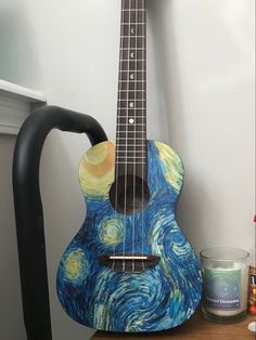 a guitar sitting on top of a wooden table