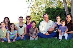 a group of people sitting in the grass