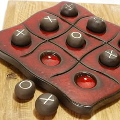 a red and black object sitting on top of a wooden table