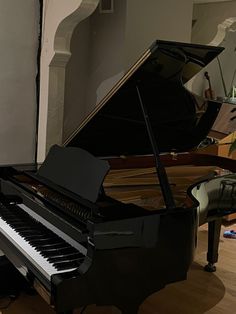 a black grand piano in a living room