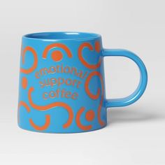 a blue and orange coffee mug with the words'international support cafe'printed on it