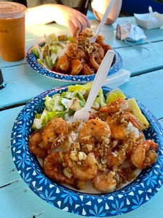 two plates of food on a blue table