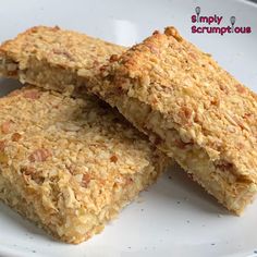 three pieces of oatmeal bars on a white plate with the words simply scrumps out