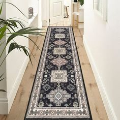 a black and white runner rug on a wooden floor