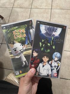 two video game covers are held up in front of a person's hand while they both have anime characters on them