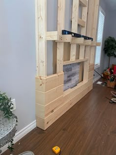 a room that has some kind of wooden shelf on the floor in front of it