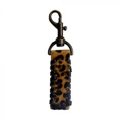 an animal print key chain hanging from a hook