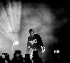 a black and white photo of a man on stage