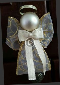 an ornament with a white bow and a pearl