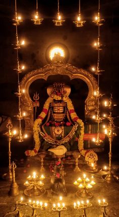 the idol is surrounded by candles and other decorations