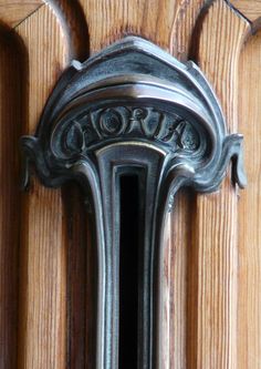 an ornate door handle on a wooden door