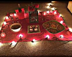 a table topped with lots of food and candles