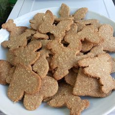 a white plate topped with cut up cookies on top of a table next to a potted plant