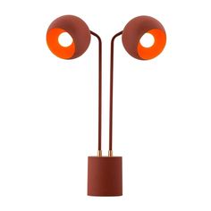 an orange floor lamp with two round lights on each side and one light on the other