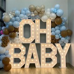 a large sign that says oh baby with balloons around it in the shape of letters