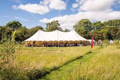 a large tent set up in the middle of a field