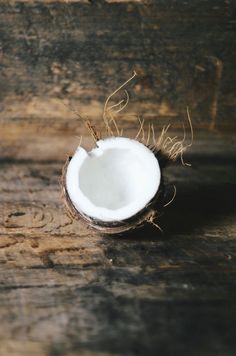 a half eaten coconut sitting on top of a wooden table