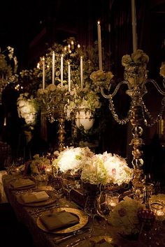 the table is set with flowers and candles