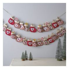 christmas stockings hanging on clothesline with trees in the background