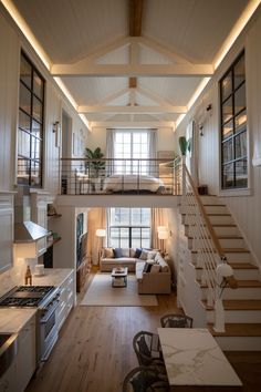 an open floor plan with stairs leading up to the loft