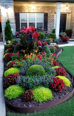 a flower garden in front of a house