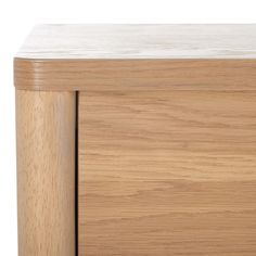 a close up of a wooden cabinet with white marble on the top and bottom part