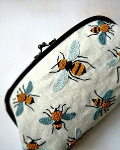 a small zippered bag with bees on it